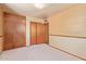 A carpeted bedroom with grasscloth wallpaper, closet and built in wardrobe at 2138 W Northview Ave, Phoenix, AZ 85021