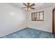 Carpeted bedroom with white walls, ceiling fan and a window at 2138 W Northview Ave, Phoenix, AZ 85021