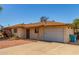 Charming single-story home with long driveway and attached garage under a clear blue sky at 2138 W Northview Ave, Phoenix, AZ 85021