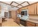 Traditional kitchen featuring wood cabinets, vintage appliances, and access to the dining room at 2138 W Northview Ave, Phoenix, AZ 85021
