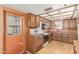 Traditional kitchen featuring wood cabinets, vintage appliances, and a door to the outdoors at 2138 W Northview Ave, Phoenix, AZ 85021