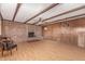 Spacious living room with wood paneling, brick fireplace, and laminate flooring at 2138 W Northview Ave, Phoenix, AZ 85021