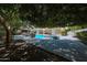 Shaded backyard with a pool, spa, and patio area, perfect for relaxation and entertainment at 2859 E Los Altos Rd, Gilbert, AZ 85297