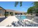 Beautiful backyard featuring a sparkling pool, tiled water feature, and well-maintained landscaping at 2859 E Los Altos Rd, Gilbert, AZ 85297