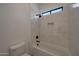 Bright bathtub with white tiled walls, niche, and black shower fixtures at 2859 E Los Altos Rd, Gilbert, AZ 85297