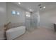 Elegant bathroom with a freestanding tub and a glass-enclosed shower with modern fixtures at 2859 E Los Altos Rd, Gilbert, AZ 85297