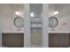 Bathroom featuring double vanities, designer mirrors and lighting, and closet access at 2859 E Los Altos Rd, Gilbert, AZ 85297