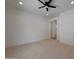 Neutral carpeted bedroom features a modern ceiling fan and an entrance to another room at 2859 E Los Altos Rd, Gilbert, AZ 85297