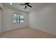Bright bedroom with a window that looks out to mature landscaping and carpeted floors at 2859 E Los Altos Rd, Gilbert, AZ 85297