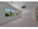 Bright, spacious bedroom with large windows, neutral carpet, and a modern ceiling fan at 2859 E Los Altos Rd, Gilbert, AZ 85297