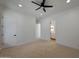 Bright bedroom with a ceiling fan, carpeted floors, and an ensuite bathroom at 2859 E Los Altos Rd, Gilbert, AZ 85297