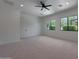 Sunlit bedroom featuring plush neutral carpet, modern ceiling fan and multiple windows at 2859 E Los Altos Rd, Gilbert, AZ 85297