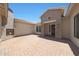 Private front courtyard with an outdoor fireplace, brick paving, and a charming entrance at 2859 E Los Altos Rd, Gilbert, AZ 85297
