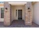 Elegant front door with brick columns and stylish lighting, offering a warm welcome at 2859 E Los Altos Rd, Gilbert, AZ 85297