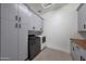 Functional laundry room with gray cabinets, butcher block countertop and modern washer/dryer at 2859 E Los Altos Rd, Gilbert, AZ 85297