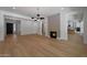 Spacious living room featuring hardwood floors, a modern fireplace, and an open floor plan at 2859 E Los Altos Rd, Gilbert, AZ 85297