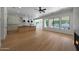 Open-concept living area with hardwood floors, modern lighting, and views of the kitchen and pool at 2859 E Los Altos Rd, Gilbert, AZ 85297