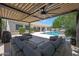 Spacious patio with outdoor seating area and views of the pool and manicured backyard at 2859 E Los Altos Rd, Gilbert, AZ 85297