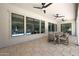 Covered patio with tile flooring, ceiling fans, and pool view through large windows at 2859 E Los Altos Rd, Gilbert, AZ 85297