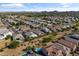 Expansive aerial view of a suburban neighborhood with tile roofs and mountain views in the distance at 36130 N Quiros Dr, Queen Creek, AZ 85143