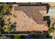Aerial view showcases the home's clay tile roof, patio, and desert landscaping with water feature and outdoor dining at 36130 N Quiros Dr, Queen Creek, AZ 85143