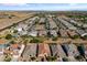 Aerial shot of a residential area with well-maintained homes, desert landscaping, and a clear blue sky at 36130 N Quiros Dr, Queen Creek, AZ 85143
