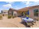 Charming brick-paved back patio with an outdoor dining set, ideal for entertaining and enjoying outdoor living at 36130 N Quiros Dr, Queen Creek, AZ 85143