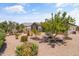 Spacious backyard showcases desert landscaping, a peaceful fountain, and a comfortable outdoor dining set at 36130 N Quiros Dr, Queen Creek, AZ 85143
