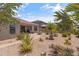 Well-maintained backyard featuring desert landscaping, a paved patio, and a charming fountain at 36130 N Quiros Dr, Queen Creek, AZ 85143