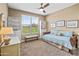 Bedroom boasting a window view, ceiling fan, and shelving at 36130 N Quiros Dr, Queen Creek, AZ 85143