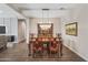 Elegant dining room with a large wooden table, ornate chairs, and a classic chandelier at 36130 N Quiros Dr, Queen Creek, AZ 85143