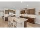 Open kitchen featuring an island with seating, stainless steel appliances, pendant lighting, and dark cabinetry at 36130 N Quiros Dr, Queen Creek, AZ 85143