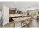Spacious kitchen boasts granite countertops, stainless steel appliances, an island with seating, and ample cabinet space at 36130 N Quiros Dr, Queen Creek, AZ 85143