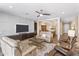 Inviting living room features comfortable seating, stylish decor, and an open layout that flows into the dining area at 36130 N Quiros Dr, Queen Creek, AZ 85143