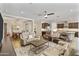 Bright living room with a ceiling fan, an open concept layout, and adjacent dining area and kitchen at 36130 N Quiros Dr, Queen Creek, AZ 85143