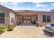 Back patio area with tile flooring, table, and plants at 36130 N Quiros Dr, Queen Creek, AZ 85143
