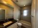Bright bathroom features a shower over tub and large mirror at 3935 E Rough Rider Rd # 1282, Phoenix, AZ 85050