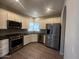 Modern kitchen featuring stainless steel appliances, white cabinets, granite countertops, and gray backsplash at 3935 E Rough Rider Rd # 1282, Phoenix, AZ 85050