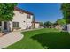 Expansive backyard featuring manicured artificial grass, a view of the pool area, and a clean, modern design at 3955 E Fox Cir, Mesa, AZ 85205