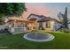 Expansive backyard with covered patio, outdoor kitchen, and trampoline offers endless entertainment possibilities at 3955 E Fox Cir, Mesa, AZ 85205