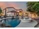 Serene backyard with a sparkling pool, spa, and outdoor living area, ideal for relaxation and entertaining at 3955 E Fox Cir, Mesa, AZ 85205