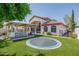 Exterior backyard showing entertainment area, bar seating, outdoor kitchen and trampoline at 3955 E Fox Cir, Mesa, AZ 85205
