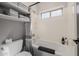 Bathroom features shelves, a soaking tub with tile surround and modern fixtures, exuding style at 3955 E Fox Cir, Mesa, AZ 85205