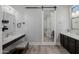 Elegant bathroom with wood floors, barn door, vanity, and marble countertops at 3955 E Fox Cir, Mesa, AZ 85205