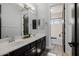 Elegant bathroom featuring dual sinks, dark cabinets, and mirrors, exuding a modern aesthetic at 3955 E Fox Cir, Mesa, AZ 85205