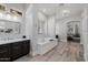 Bright bathroom with a soaking tub, dual vanities, and modern lighting, creating a spa-like oasis for relaxation at 3955 E Fox Cir, Mesa, AZ 85205