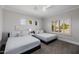 Bedroom features 2 beds, a ceiling fan, and a window providing natural light for a restful space at 3955 E Fox Cir, Mesa, AZ 85205