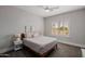 Bright bedroom with neutral walls, a ceiling fan, and a window offering natural light at 3955 E Fox Cir, Mesa, AZ 85205