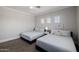 Bedroom features 2 beds, a ceiling fan, and a window providing natural light for a restful space at 3955 E Fox Cir, Mesa, AZ 85205
