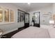 Charming bedroom featuring wood floors, a built-in bookcase, and sliding doors at 3955 E Fox Cir, Mesa, AZ 85205